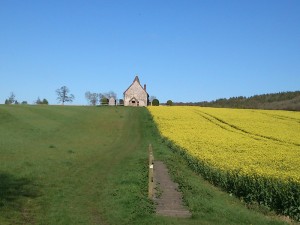 Church set off road in field possibly site of a plague village