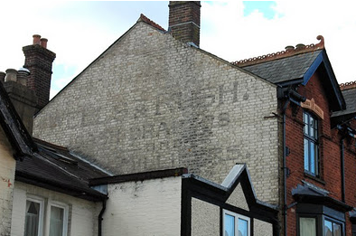 Painted sign still visible on the wall of the building